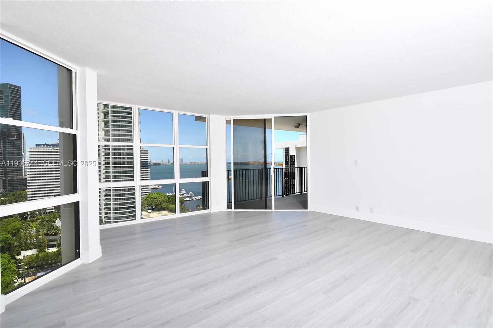 1901 Brickell Avenue, Unit B2209 Miami, FL 33129 - Photo 5 of 8 a view of an empty room with wooden floor and a fireplace
