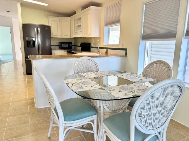 a dining room with furniture a window and kitchen view