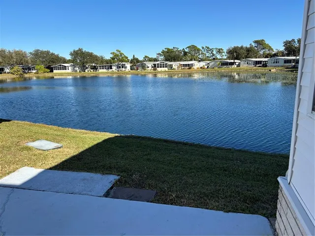 a view of a lake with houses in the back