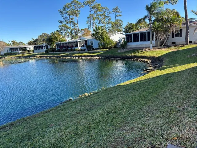 a view of a house with a yard and swimming pool