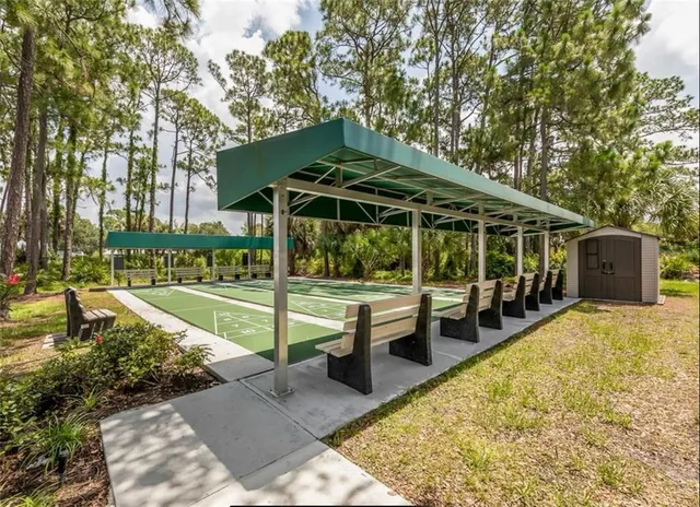 a view of a house with backyard porch and sitting area