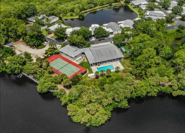 an aerial view of a house with a yard and lake view