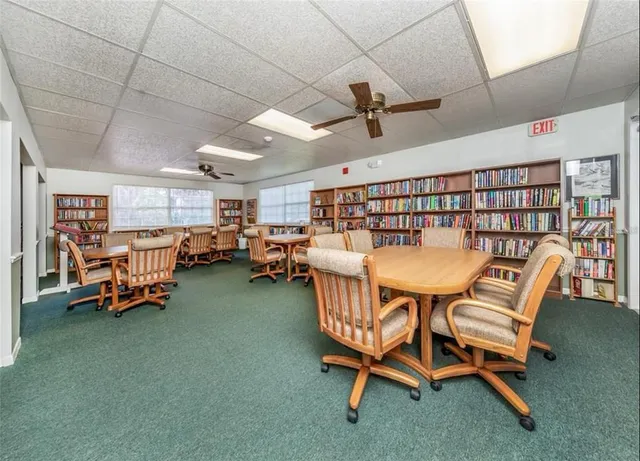 a dining room with furniture and a rug