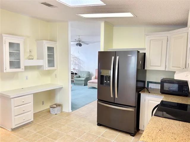 a kitchen with stainless steel appliances granite countertop a refrigerator and a stove