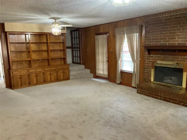 a view of an empty room with a fireplace