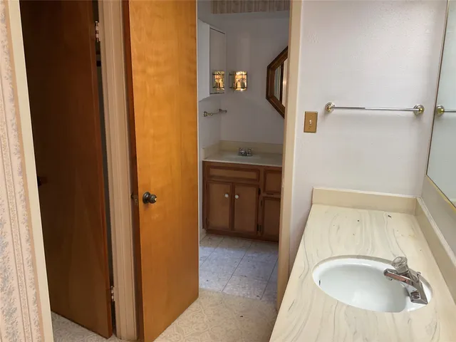 a bathroom with a sink and a mirror