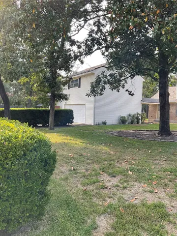 a view of a house with a yard balcony and sitting area