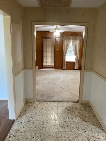 a view of a room with a wooden door