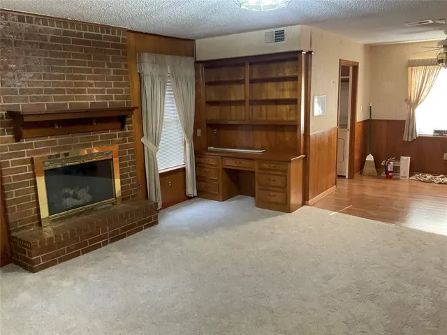a view of a livingroom with furniture and a fireplace