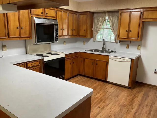 a kitchen with stainless steel appliances a stove a sink and a microwave