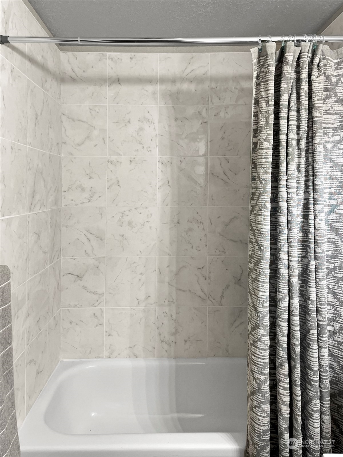 14401 Southeast Petrovitsky Road, Unit C103 Renton, WA 98058 - Photo 15 of 29 a bathroom with a shower and a bath tub