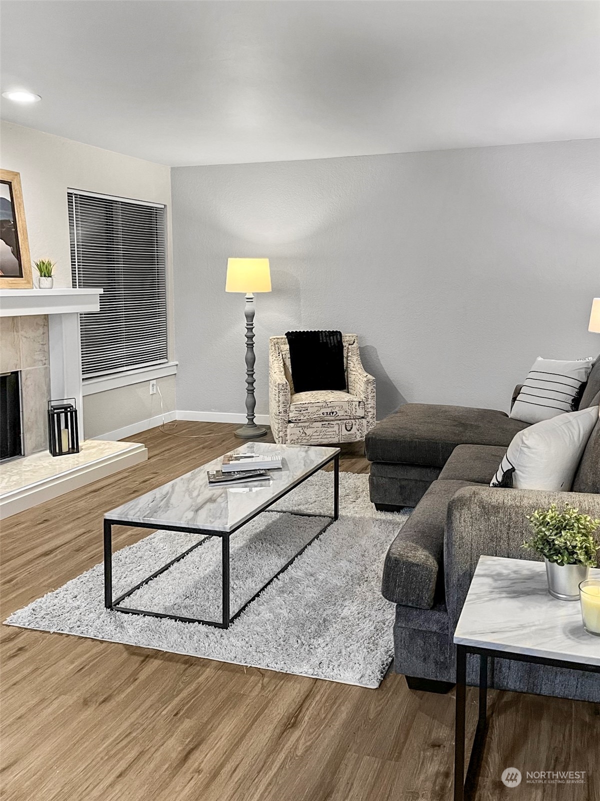 14401 Southeast Petrovitsky Road, Unit C103 Renton, WA 98058 - Photo 2 of 29 a living room with furniture and a wooden floor