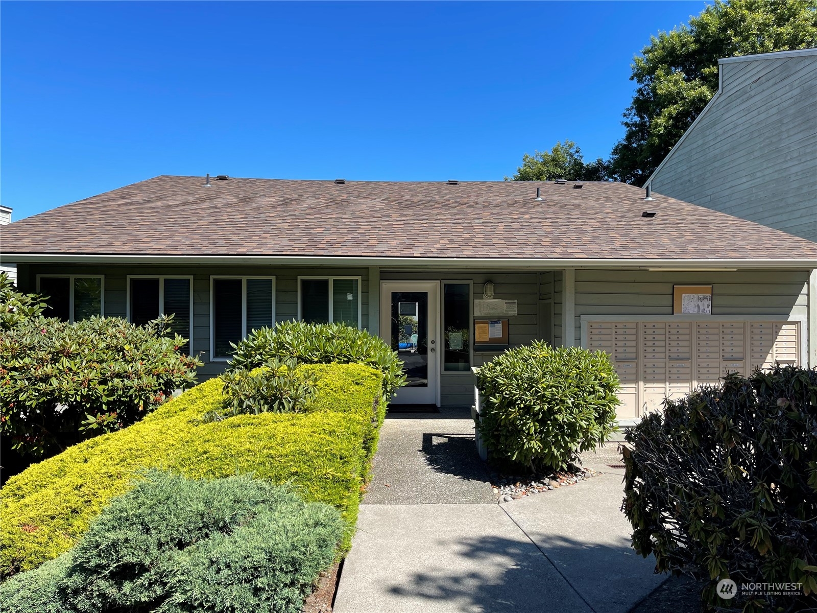 14401 Southeast Petrovitsky Road, Unit C103 Renton, WA 98058 - Photo 26 of 29 a front view of a house with a garden