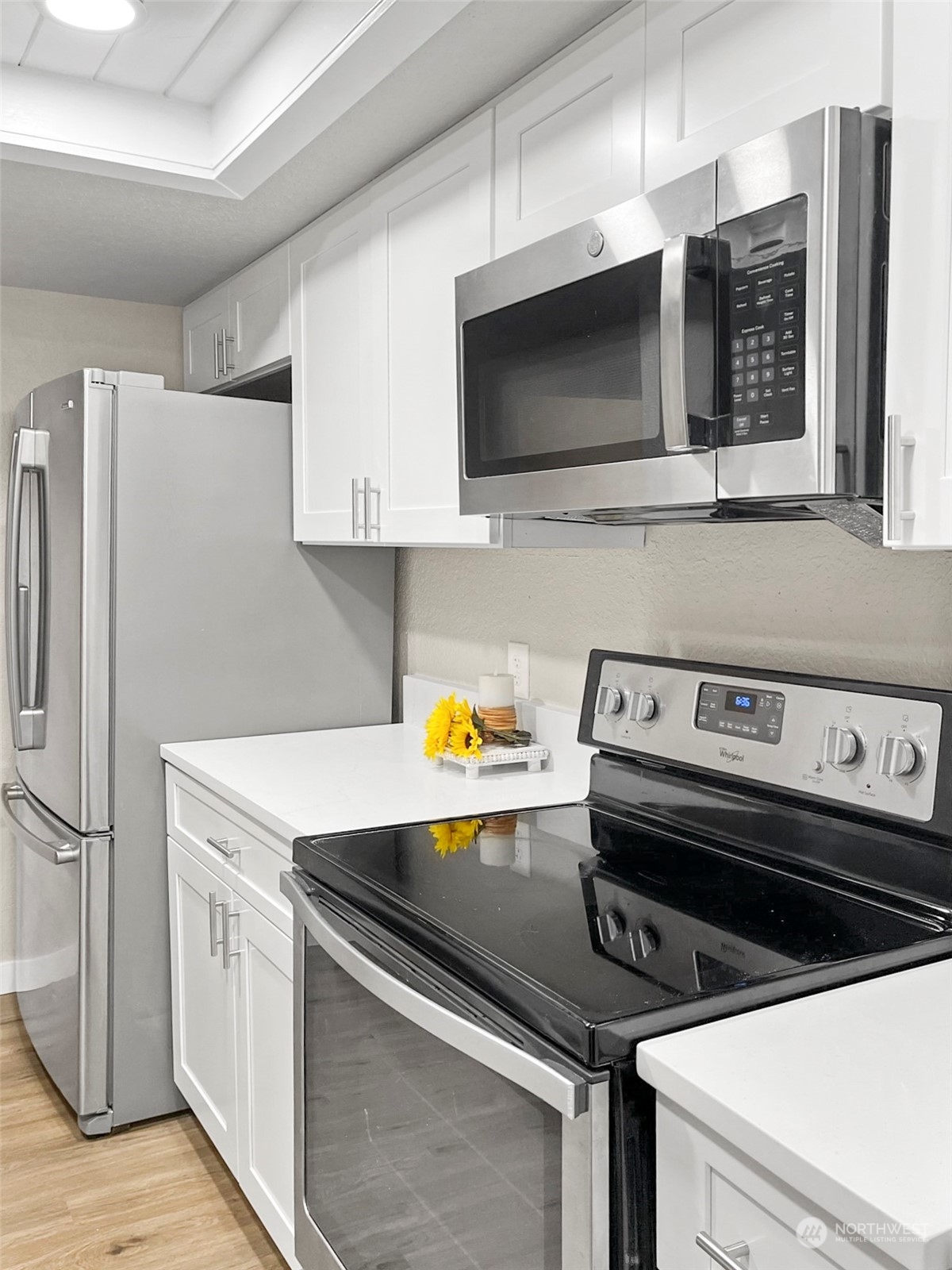14401 Southeast Petrovitsky Road, Unit C103 Renton, WA 98058 - Photo 7 of 29 a kitchen with a stove and a microwave