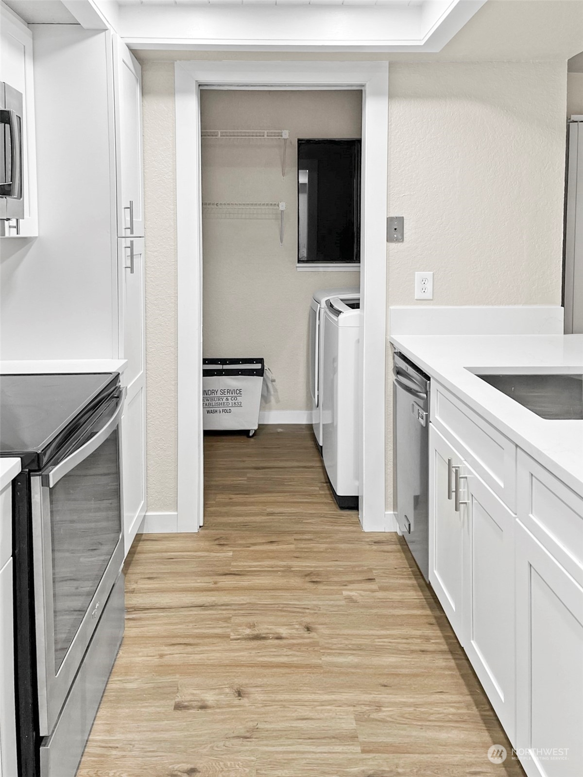 14401 Southeast Petrovitsky Road, Unit C103 Renton, WA 98058 - Photo 9 of 29 a view of a kitchen from the hallway