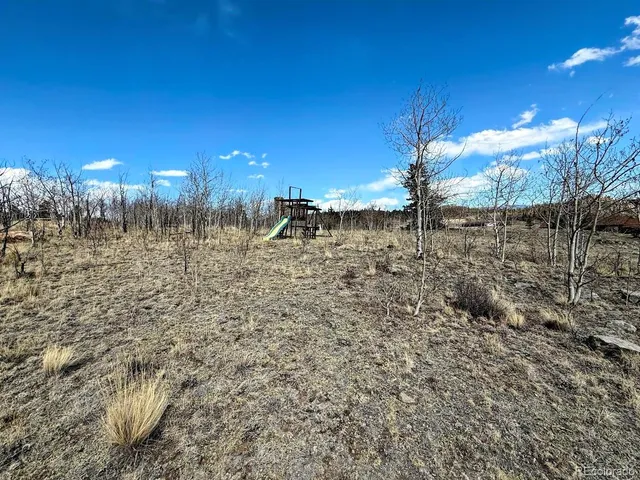 a view of yard with wooden fence