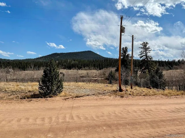 a view of a house with a yard covered in snow