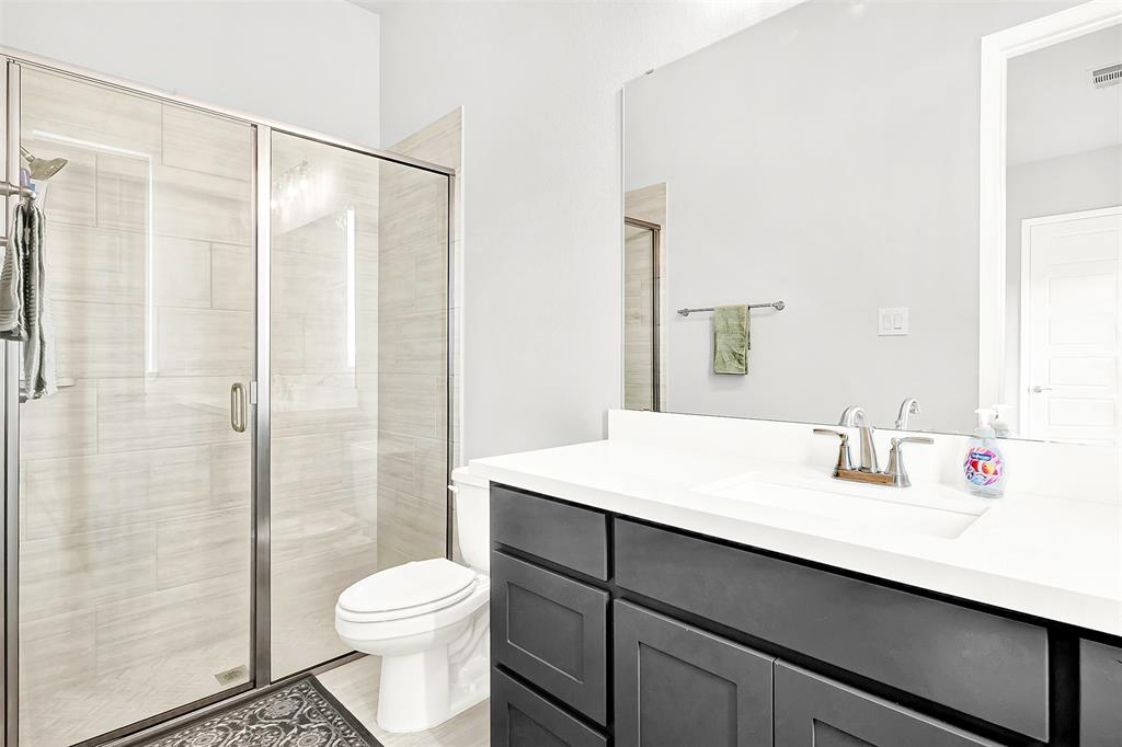 1004 Open Range Drive Mansfield, TX 76063 - Photo 23 of 40 a bathroom with a sink toilet and shower