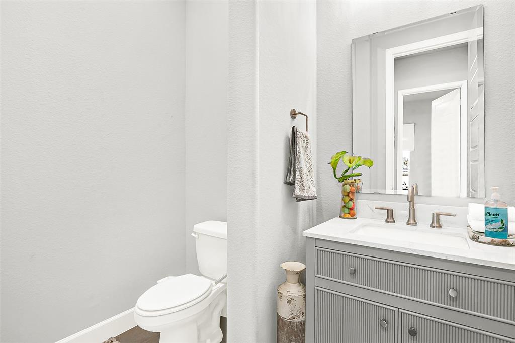 1004 Open Range Drive Mansfield, TX 76063 - Photo 7 of 40 a bathroom with a toilet sink and mirror