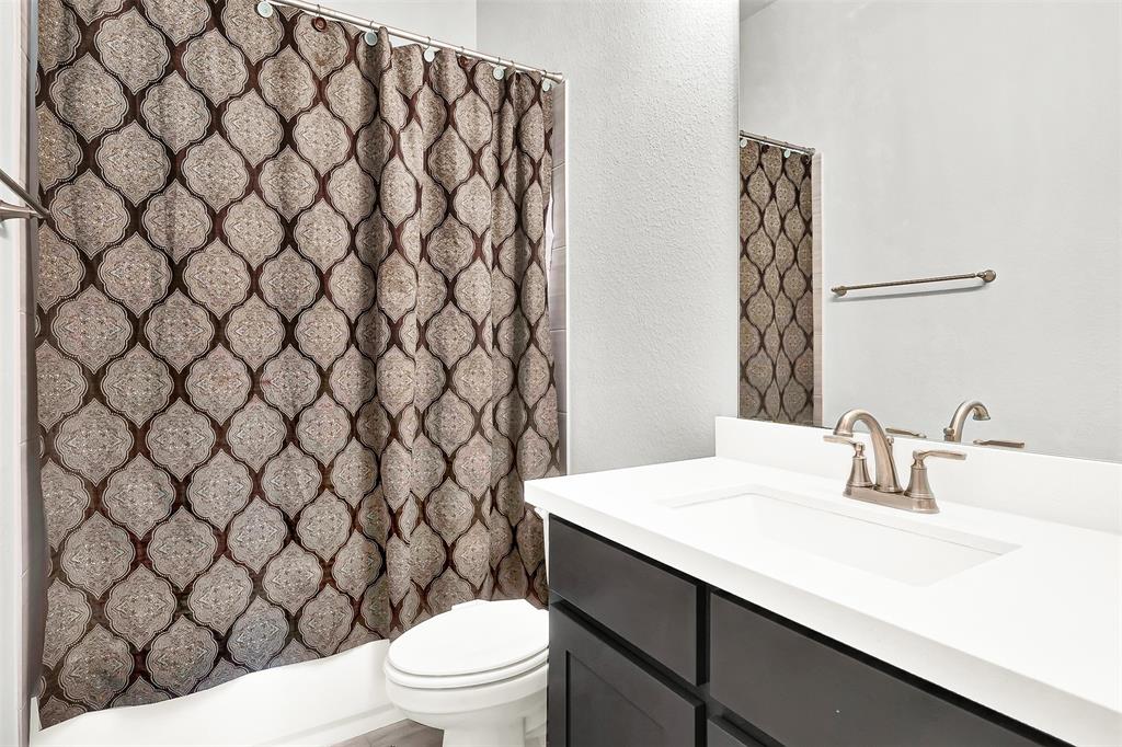 1004 Open Range Drive Mansfield, TX 76063 - Photo 9 of 40 a bathroom with a sink and a toilet