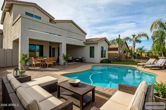 a view of a house with swimming pool and furniture