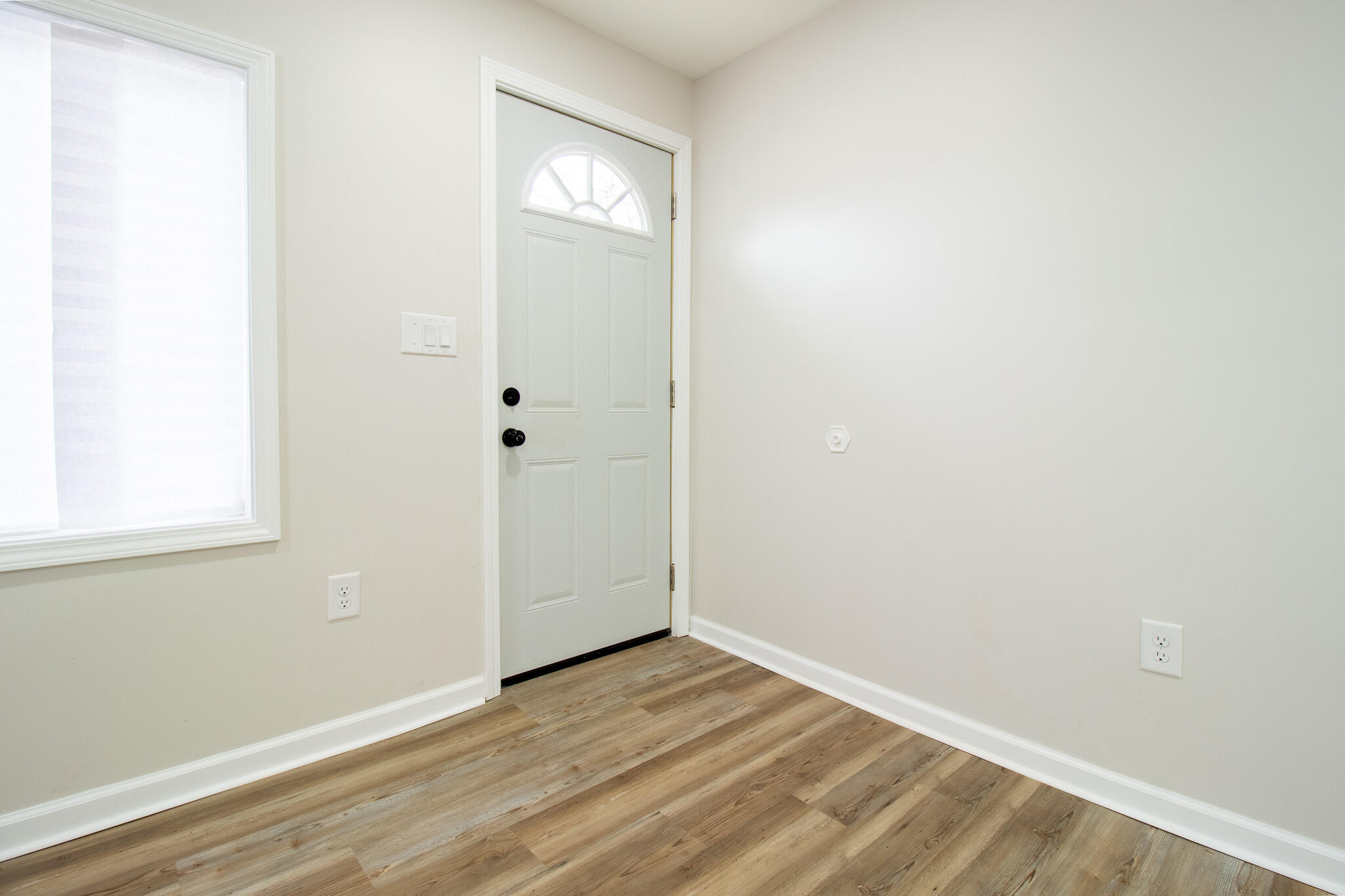 1755 Ralston Street Gary, IN 46406 - Photo 8 of 29 an empty room with wooden floor and windows