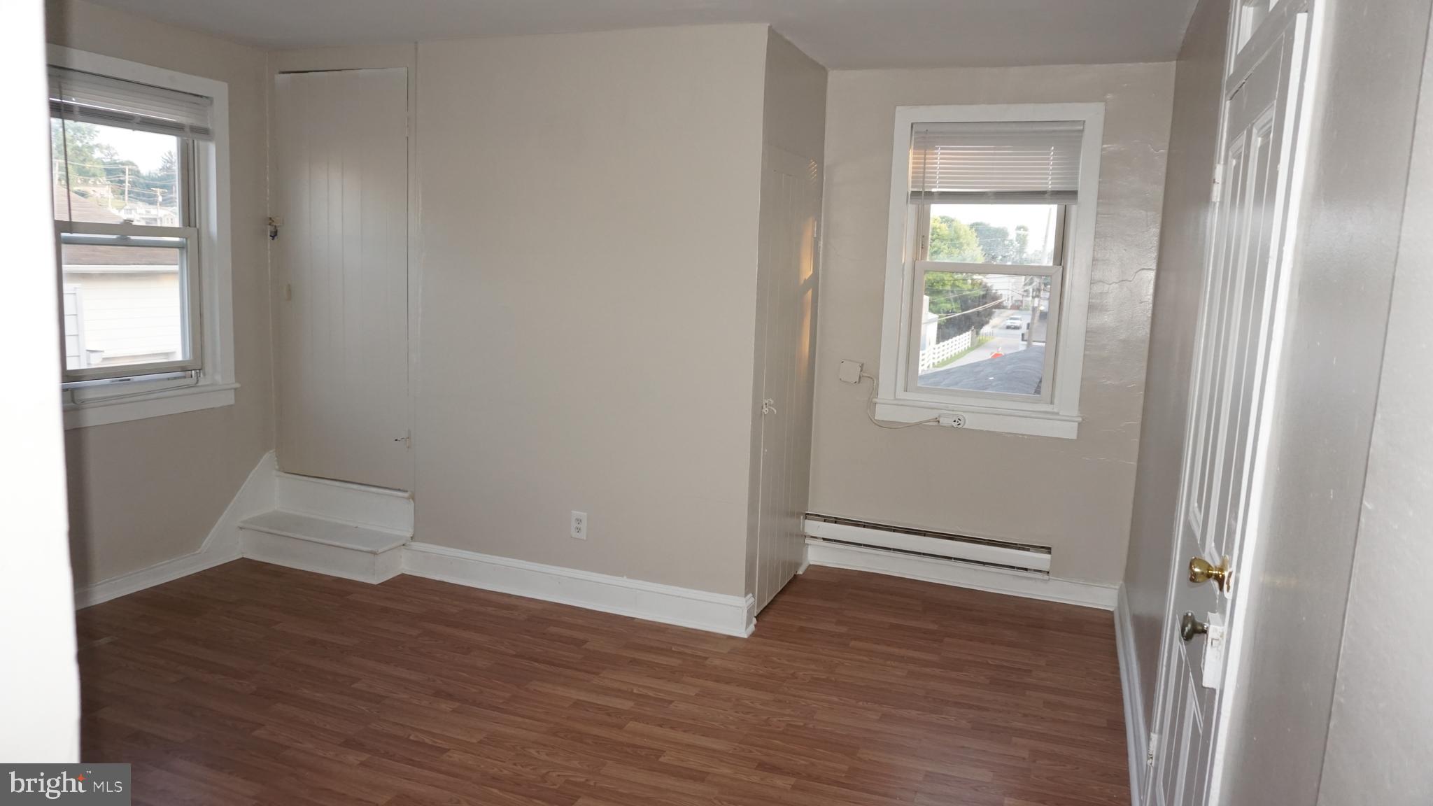 276 East Main Street, Unit 4 Westminster, MD 21157 - Photo 12 of 26 an empty room with wooden floor closet and windows