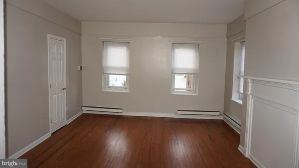 a view of wooden floor and windows in a room