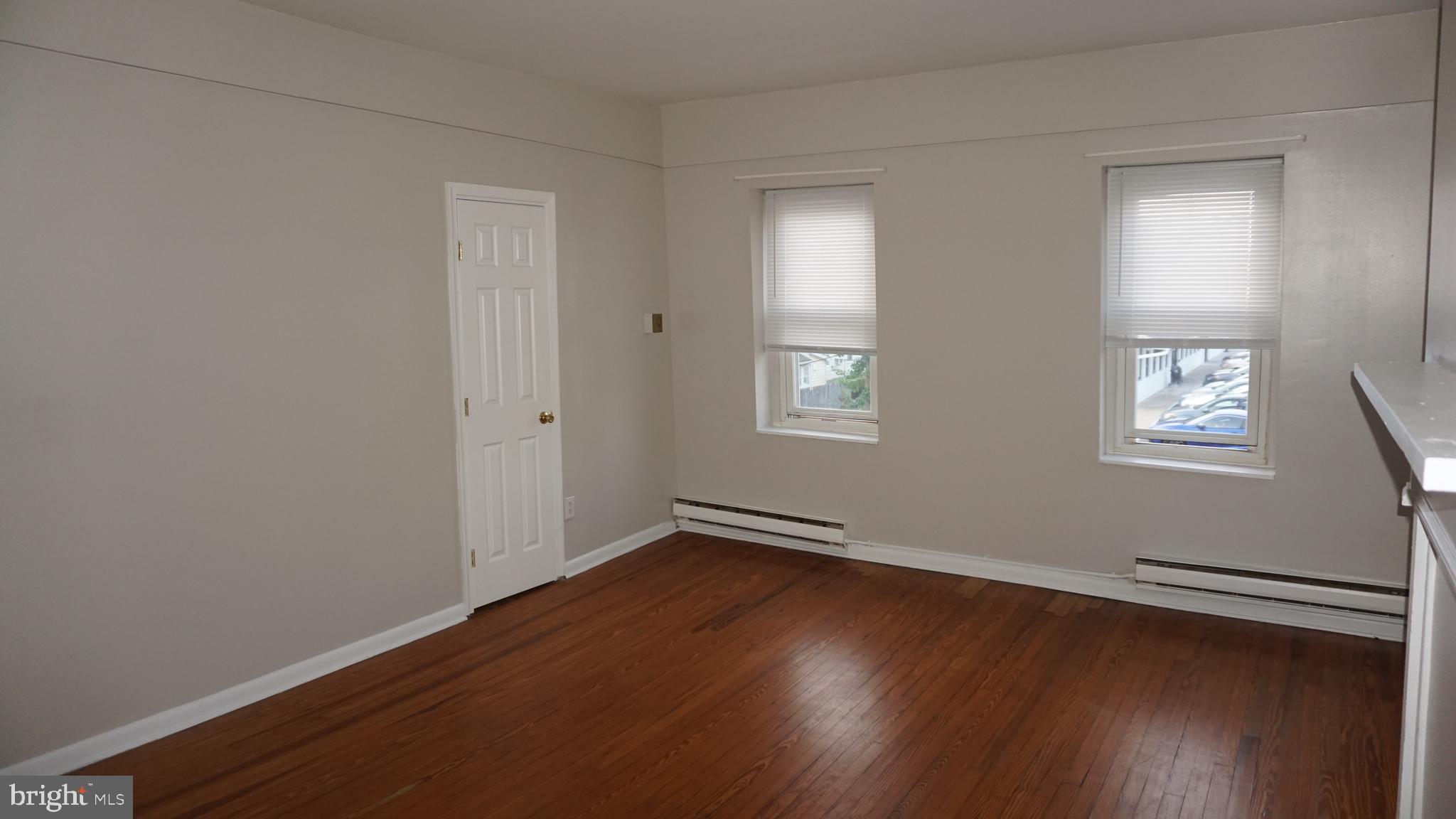 276 East Main Street, Unit 4 Westminster, MD 21157 - Photo 14 of 26 an empty room with wooden floor and windows