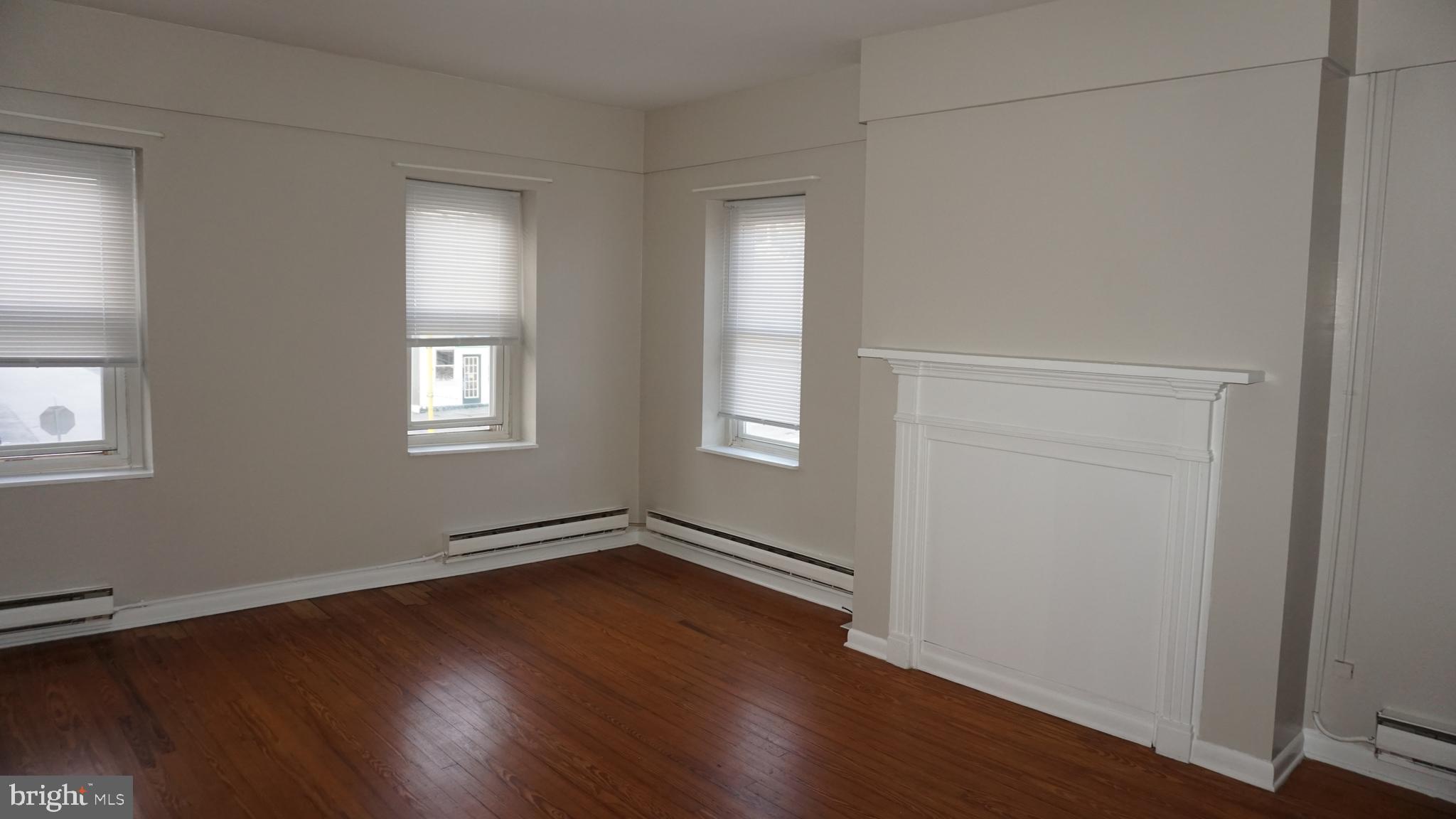 276 East Main Street, Unit 4 Westminster, MD 21157 - Photo 15 of 26 a view of an empty room with wooden floor and a window