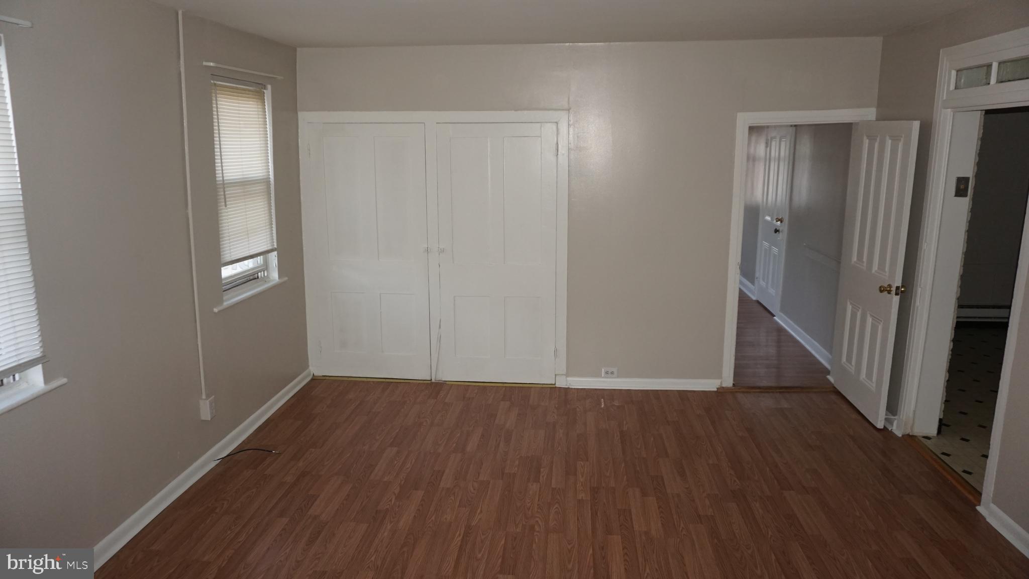 276 East Main Street, Unit 4 Westminster, MD 21157 - Photo 16 of 26 a view of an empty room with wooden floor and a window