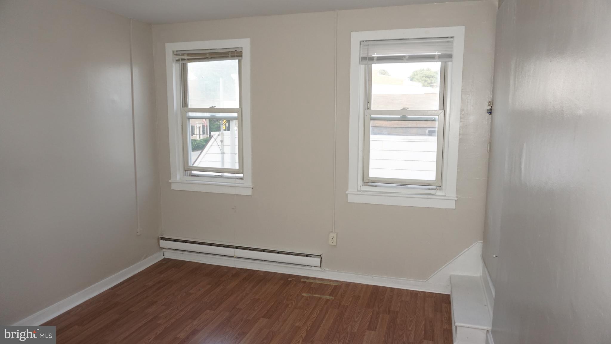 276 East Main Street, Unit 4 Westminster, MD 21157 - Photo 17 of 26 a view of an empty room with wooden floor and a window