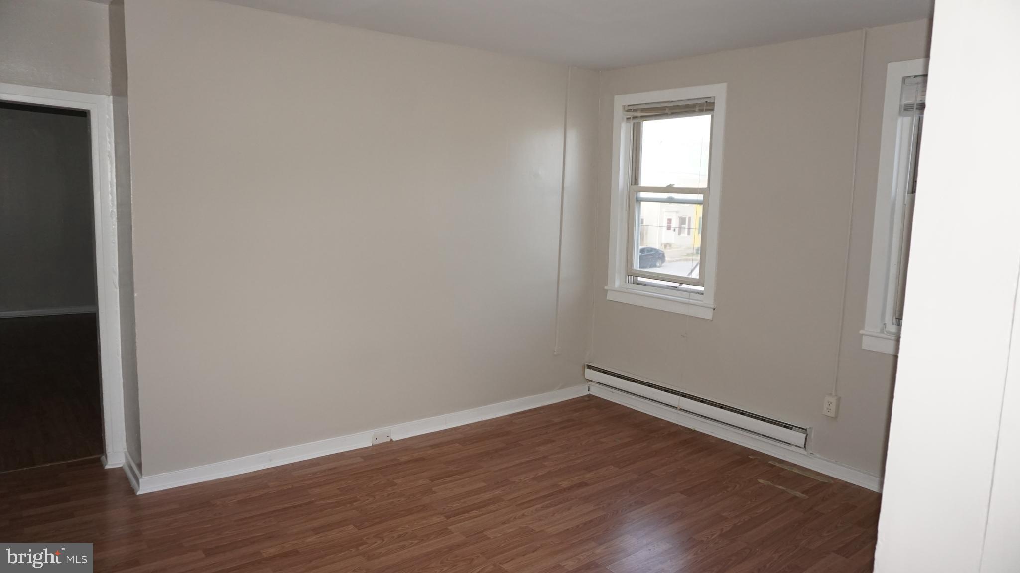 276 East Main Street, Unit 4 Westminster, MD 21157 - Photo 18 of 26 an empty room with wooden floor and windows