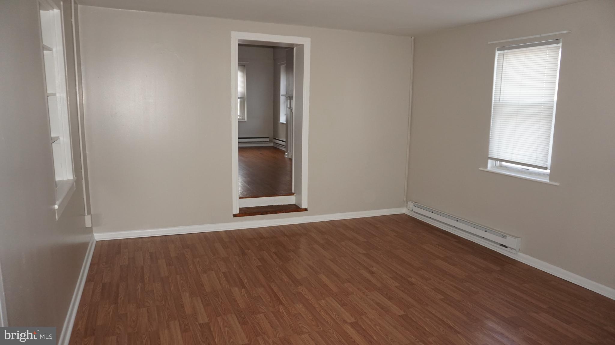 276 East Main Street, Unit 4 Westminster, MD 21157 - Photo 19 of 26 an empty room with wooden floor and windows