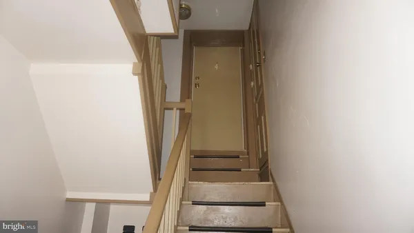 a view of staircase with white walls