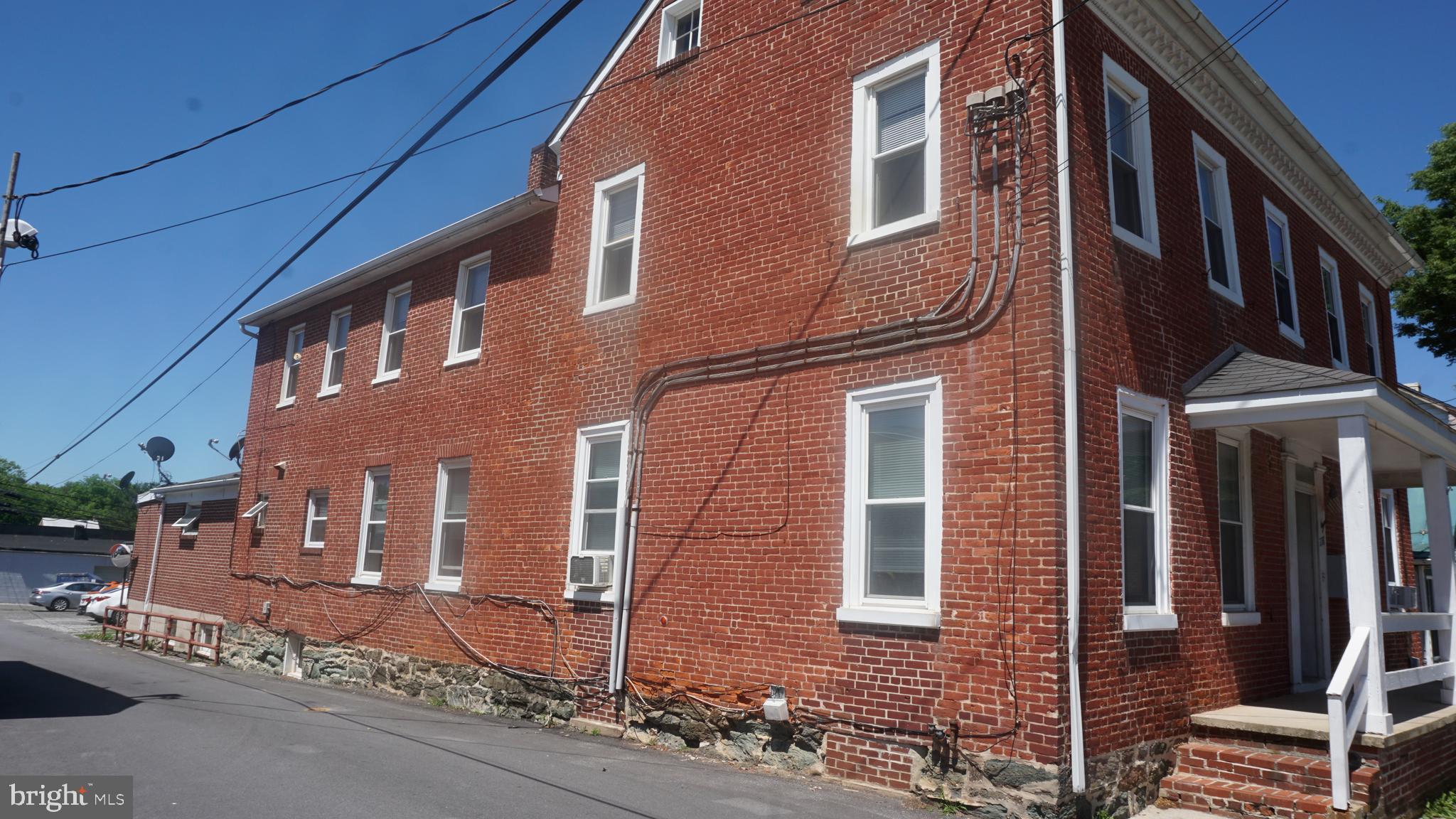 276 East Main Street, Unit 4 Westminster, MD 21157 - Photo 23 of 26 front view of a brick house with a street