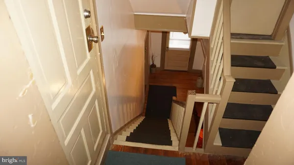 a view of an entryway with wooden floor