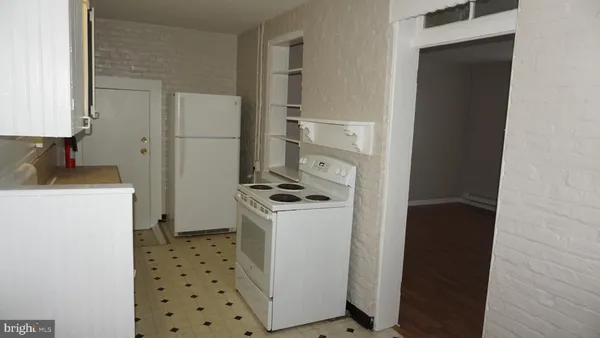 a kitchen with a stove a refrigerator and a sink