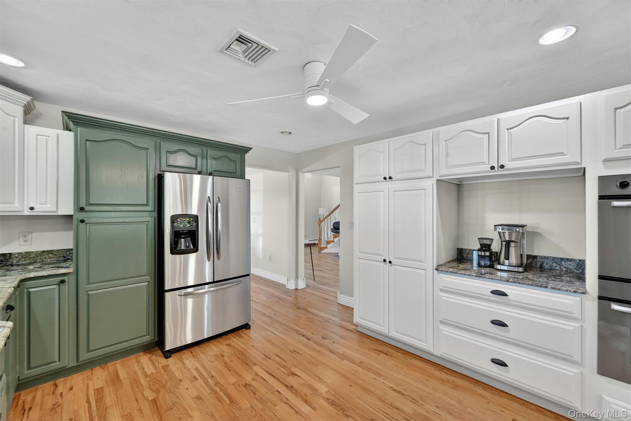 954 Ridgebury Road New Hampton, NY 10958 - Photo 22 of 45 A thoughtful kitchen layout offers built-in storage, stainless steel appliances, and a natural connection to the main living areas. Just beyond the doorway to the right of the refrigerator is the formal dining room, perfectly situated for hosting holidays and guests throughout the year.