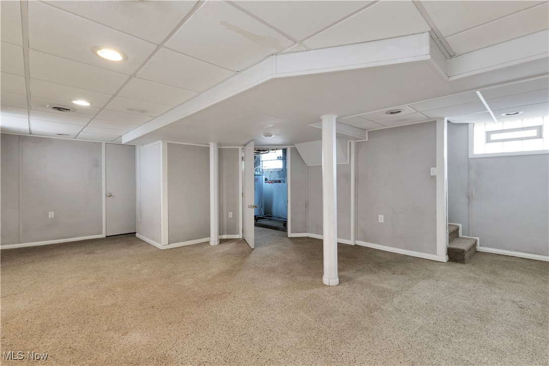 48265 Middle Ridge Road Amherst, OH 44001 - Photo 26 of 43 Partially finished/waterproofed basement with nature stone flooring, paneled walls and drop ceiling.
