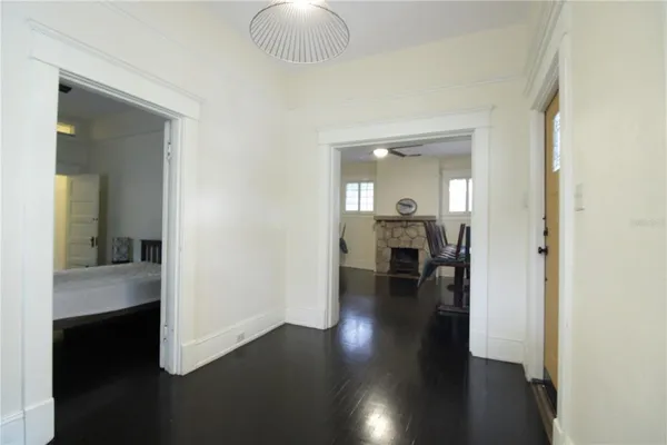 a view of a hallway view with wooden floor and living room