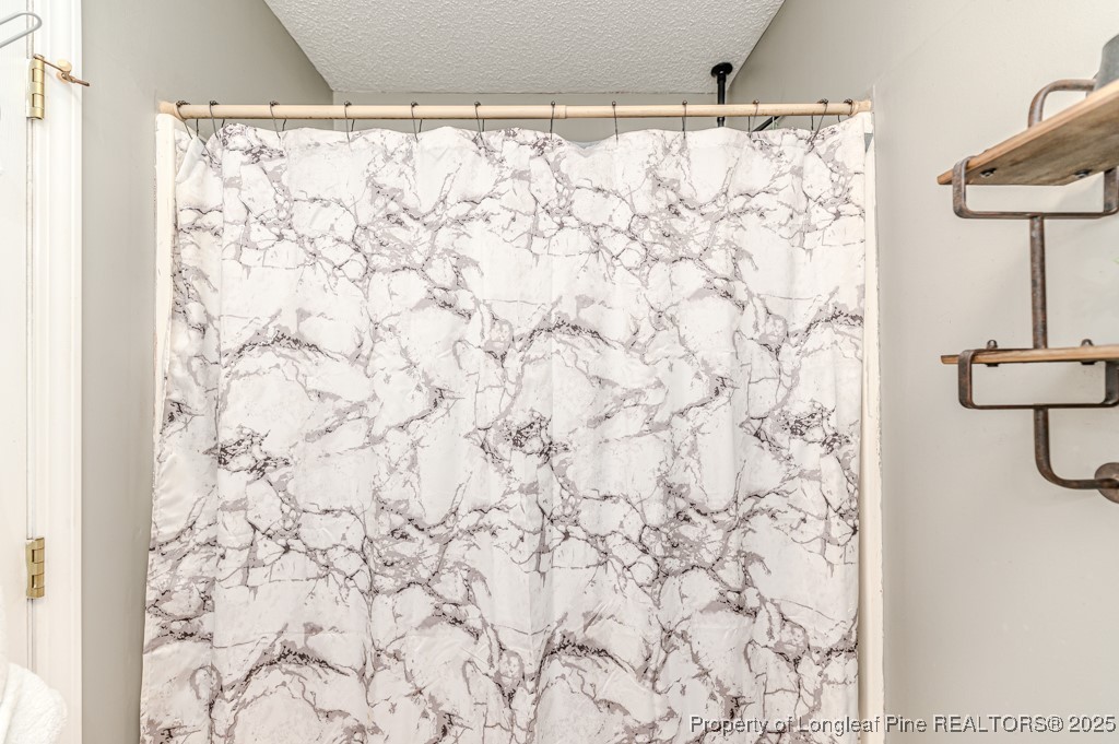 476 Riddle Road Sanford, NC 27330 - Photo 16 of 34 a bathroom with a shower curtain