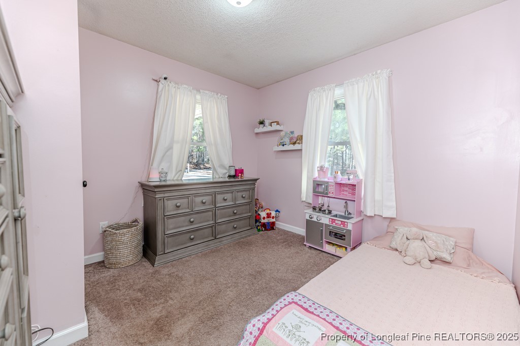 476 Riddle Road Sanford, NC 27330 - Photo 18 of 34 a bed room with a bed and a window