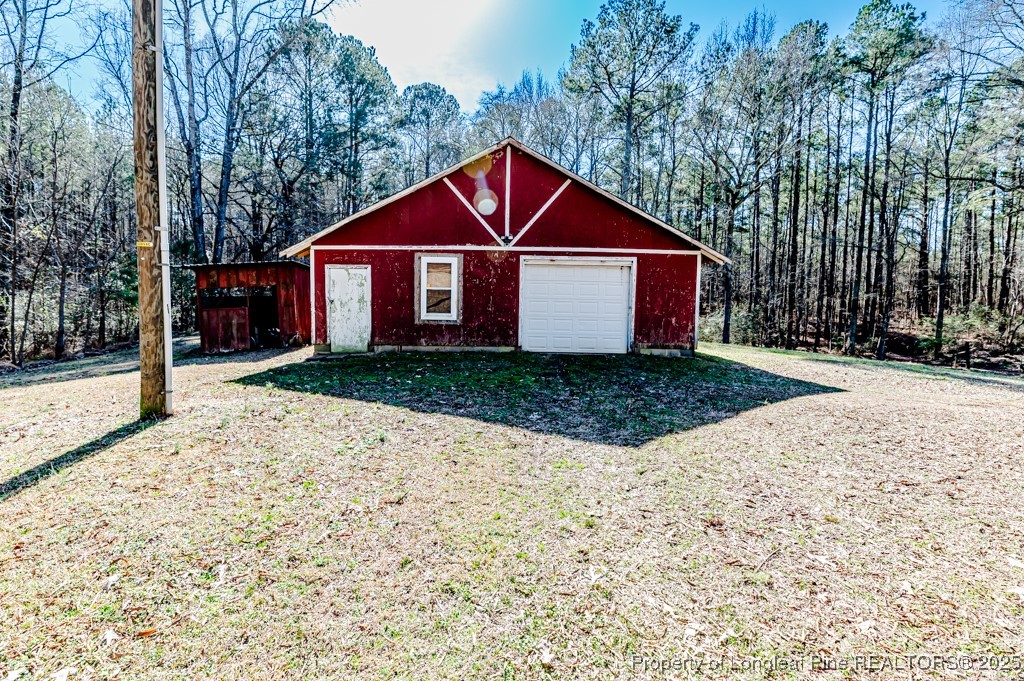 476 Riddle Road Sanford, NC 27330 - Photo 23 of 34 a front view of a house with a yard