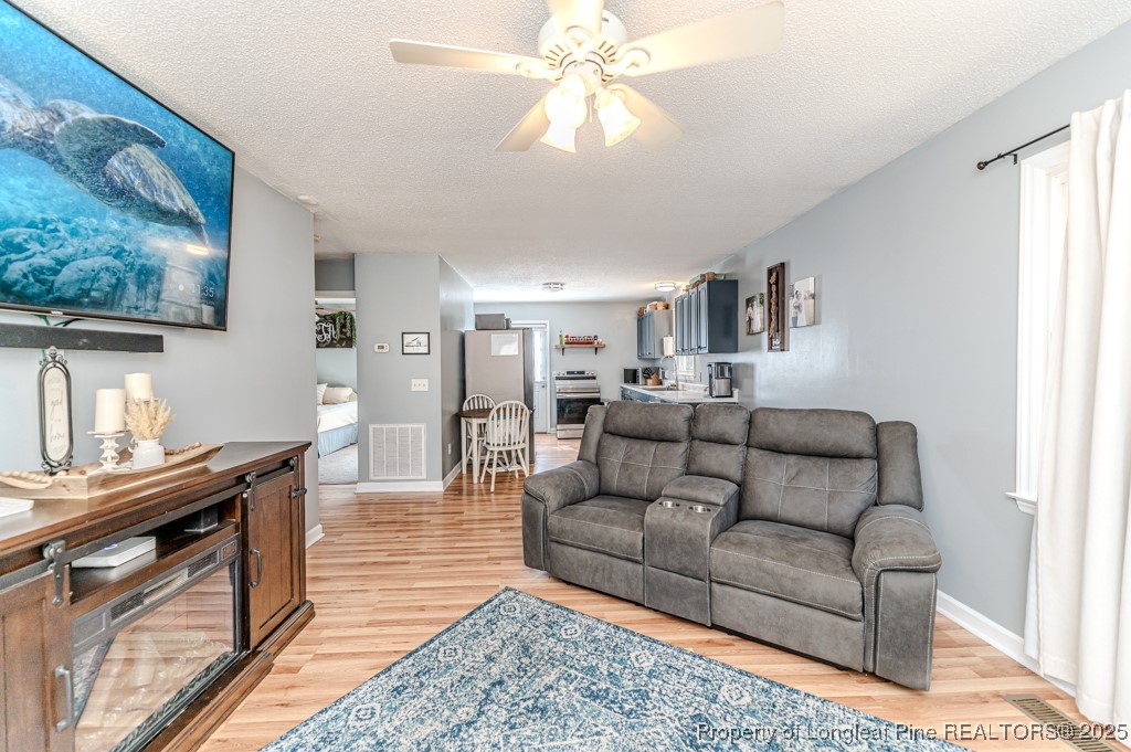 476 Riddle Road Sanford, NC 27330 - Photo 5 of 34 a living room with furniture and a flat screen tv