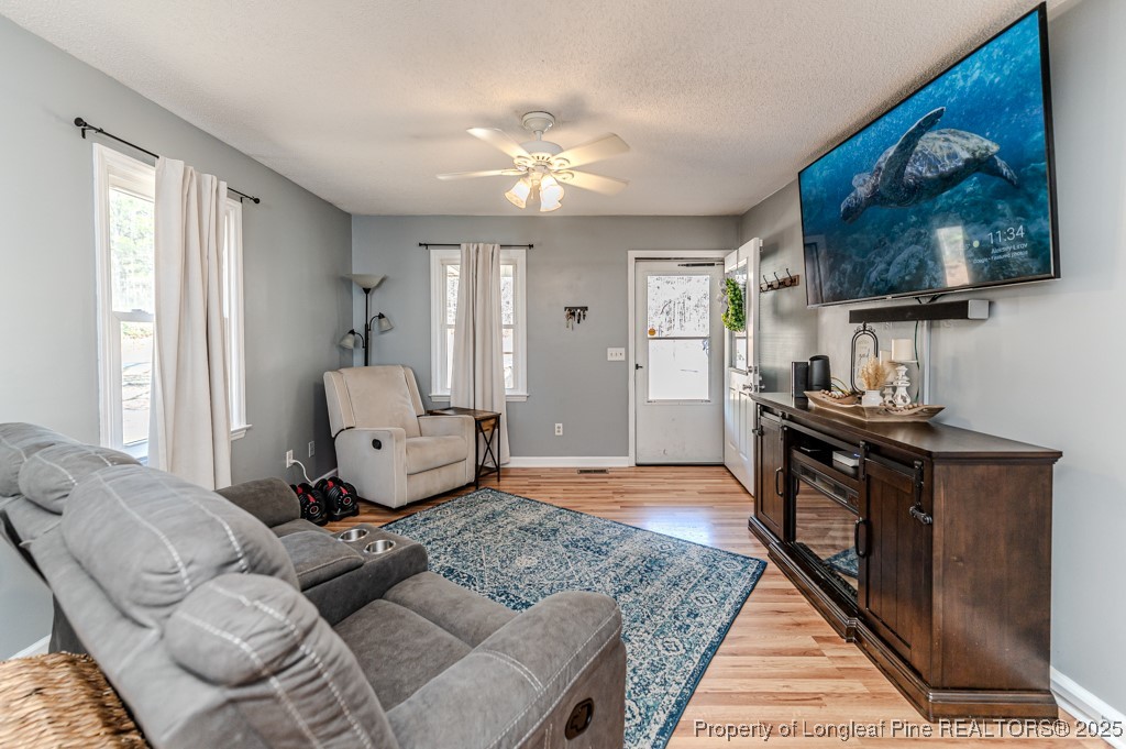 476 Riddle Road Sanford, NC 27330 - Photo 6 of 34 a living room with furniture and a flat screen tv