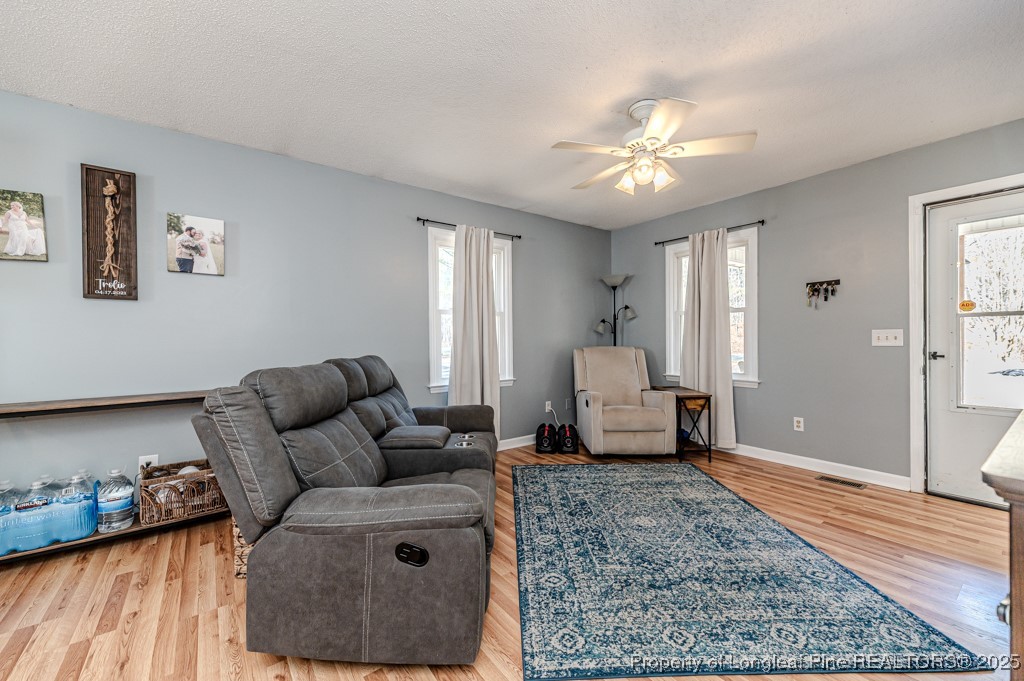 476 Riddle Road Sanford, NC 27330 - Photo 7 of 34 a living room with furniture and a chandelier