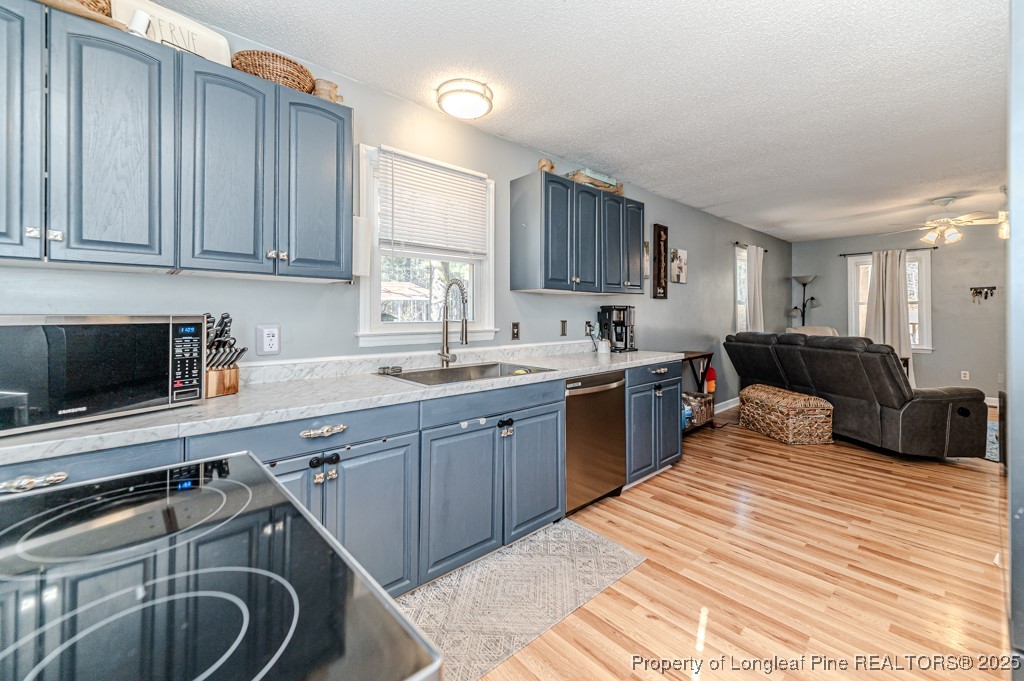 476 Riddle Road Sanford, NC 27330 - Photo 10 of 34 a kitchen with stainless steel appliances granite countertop a sink stove and cabinets