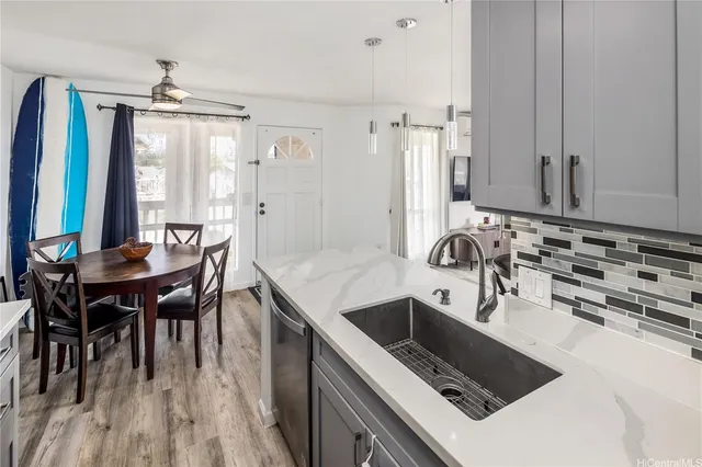 a kitchen with granite countertop a sink stove and cabinets