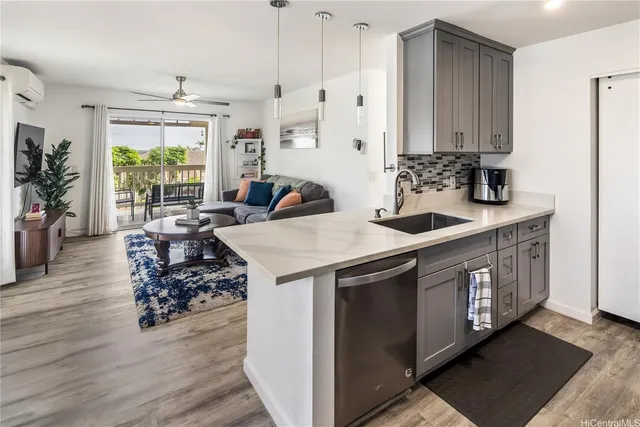 a kitchen with stainless steel appliances granite countertop a sink stove and wooden floor